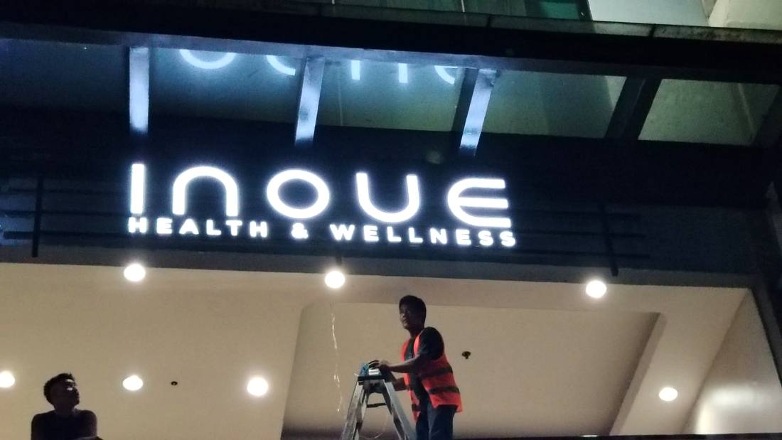 Inoue Health and Wellness sign glowing after repair