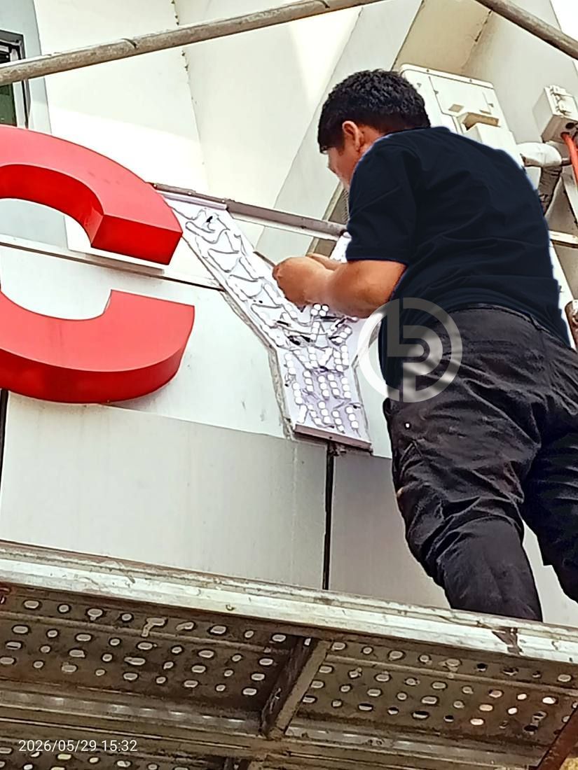 Close-up of LED modules being replaced inside a channel letter